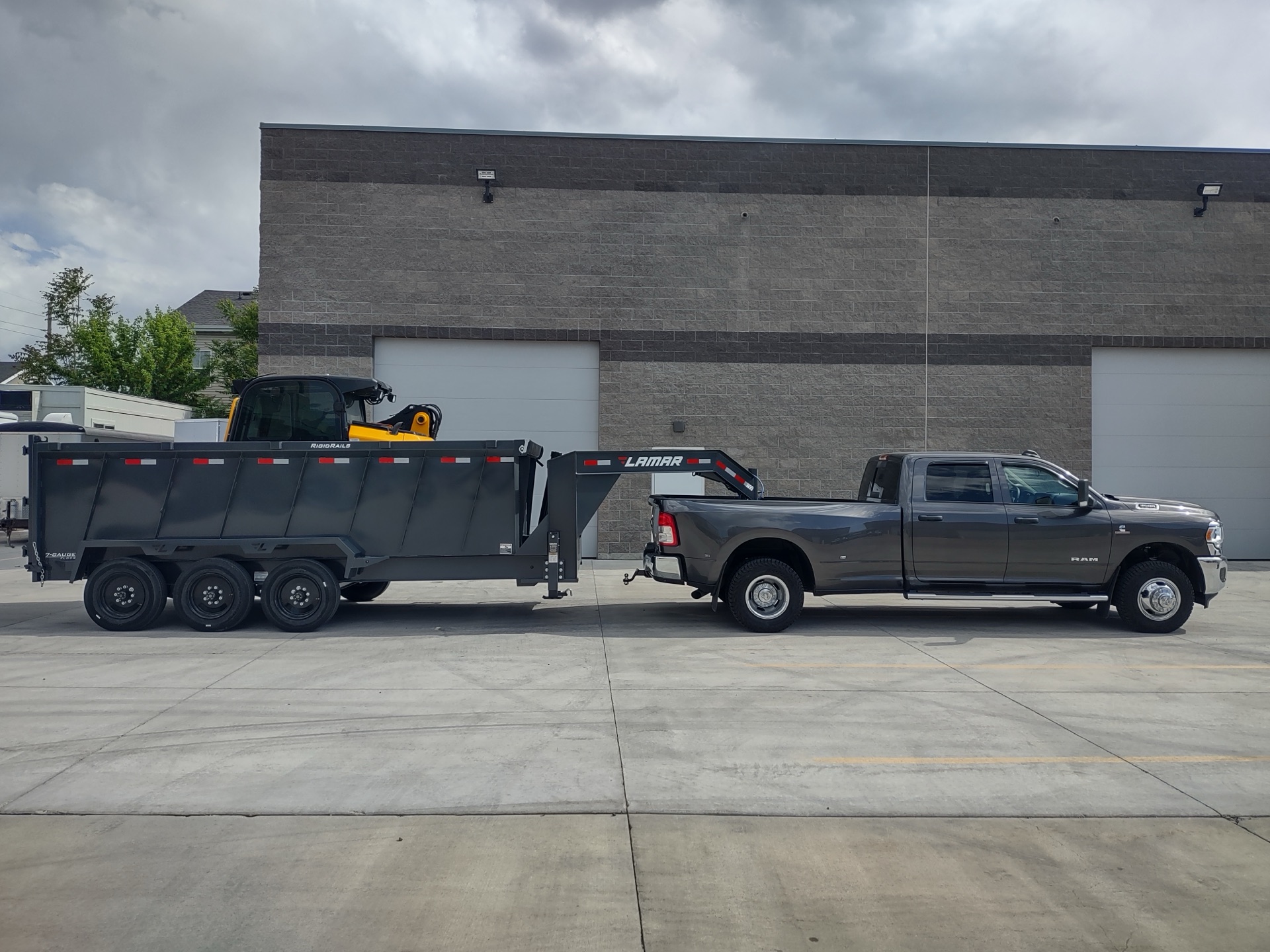 Ram dually with Stumpt gooseneck trailer and skid-steer loaded